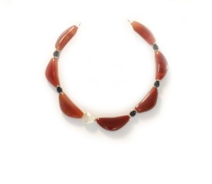 A Choker of Quarter Moon Shaped Rust Agate beads with White Pearl